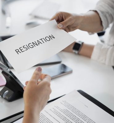 employee-holding-resignation-letter-high-angle